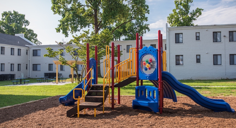 Colorful playground set in front of Silver Hill Apartments