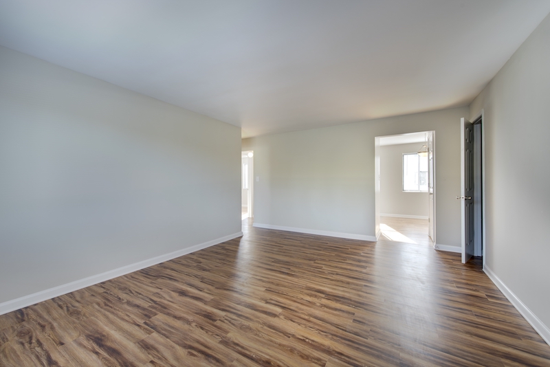 Unfurnished room with wood-style flooring and white walls